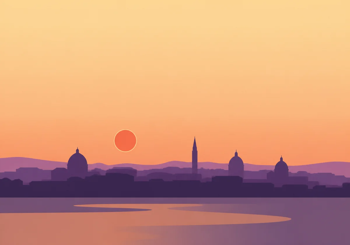 Old European skyline with domes and a tower against an apricot evening sky