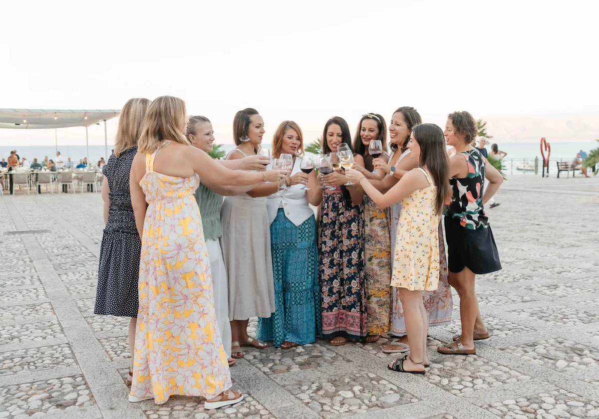 The retreat group clinking glasses in a circle on the promenade