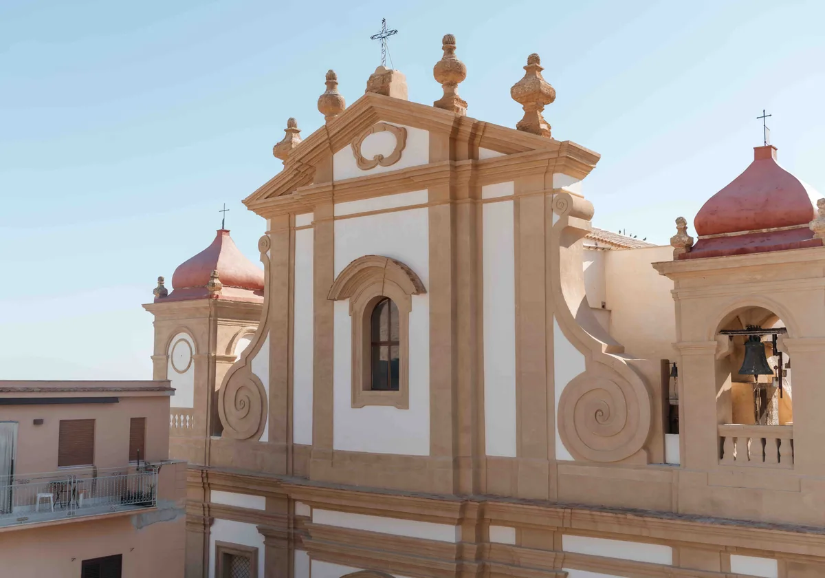 A baroque church facade in Castellammare del Golfo against a clear sky