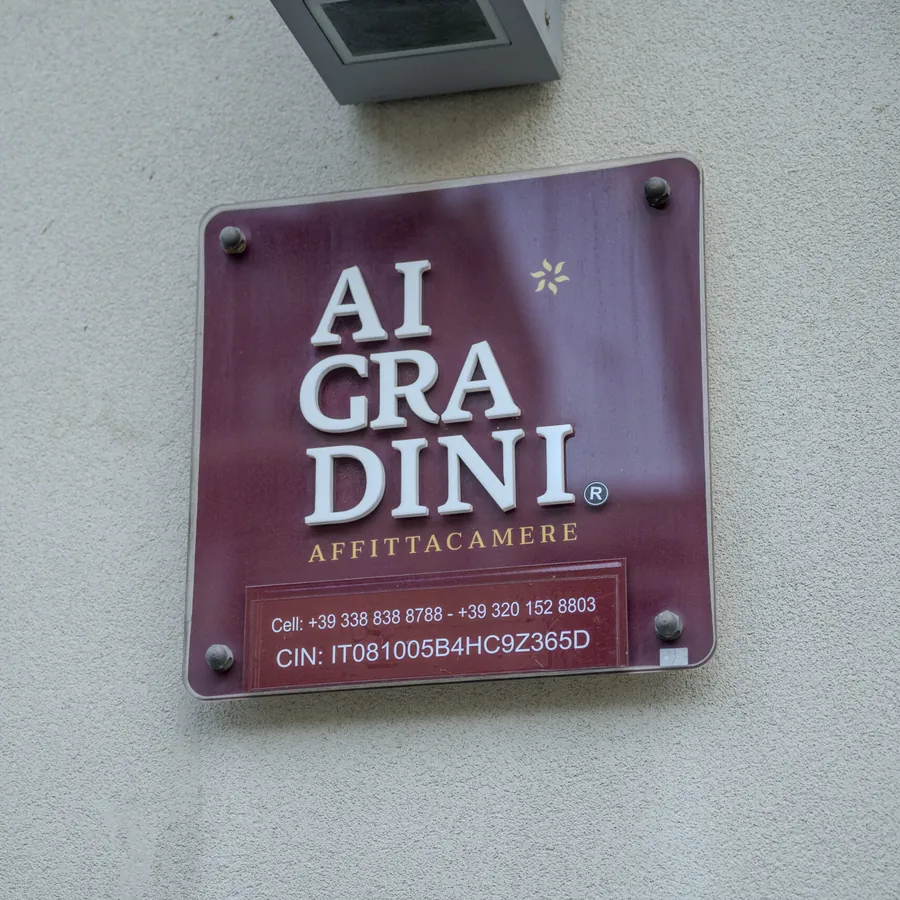The Ai Gradini guesthouse nameplate where the retreat group stayed