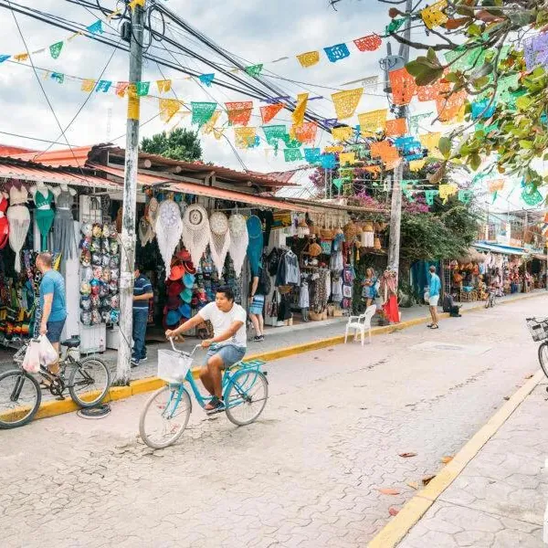 A shop-lined Tulum street hung with colorful papel picado