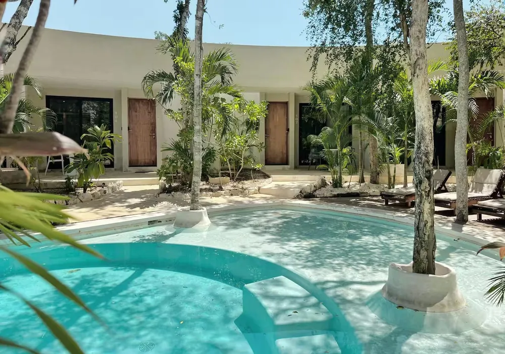 The main pool curving through the palms and jungle at Soul Circle